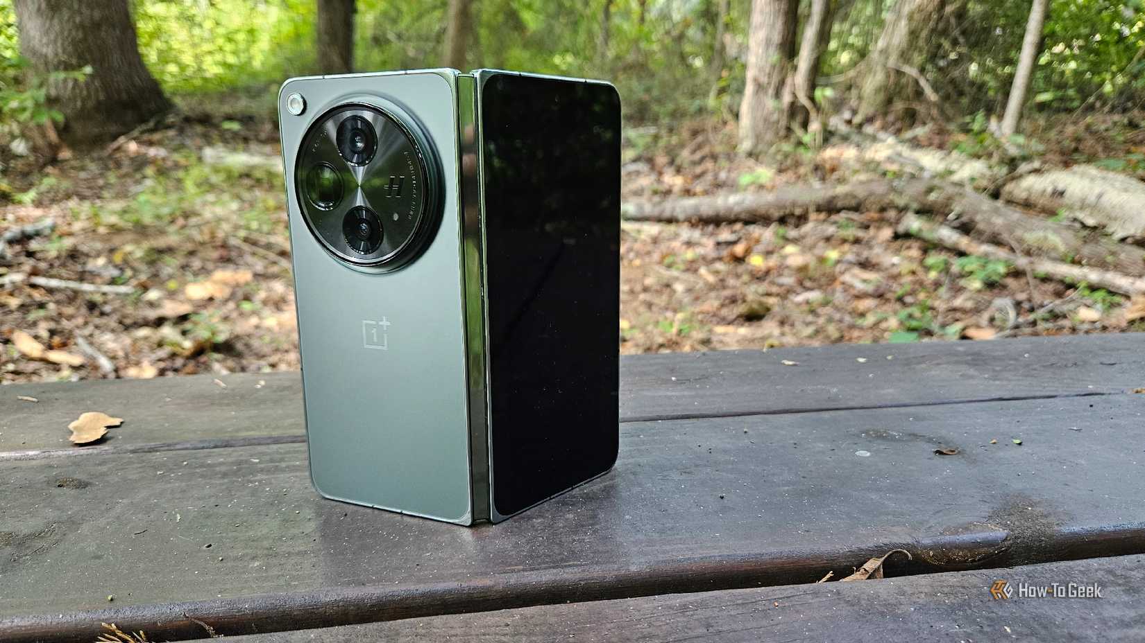 A OnePlus Open standing upright in a bench. 